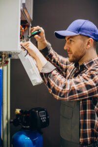 Technician Repairing Home Heating System Emergency Repair